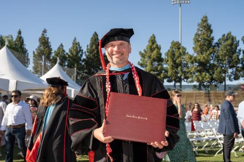 A student holding degree