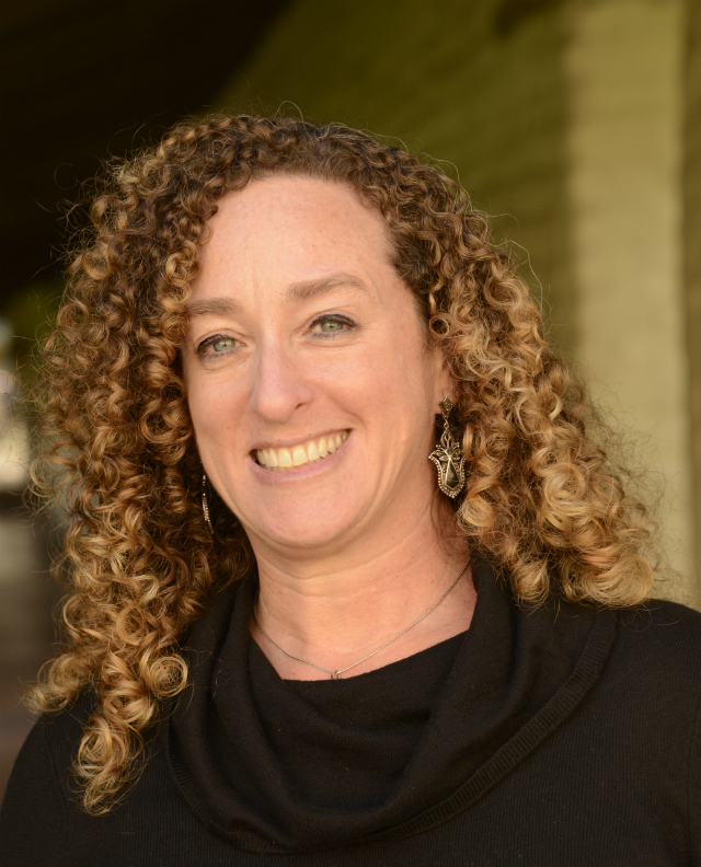 A person smiling in an outdoor setting. image link to story